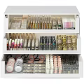 White Drawer Cosmetic Organizer Filled With Perfumes And Makeup Products