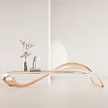 Golden Sleek Curved Public Chair With Decorative Sculpture Dried Flower Vase And Round White Object