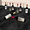Several Wine Bottles And Two Wine Glasses On Gray Countertop With Wine Rack