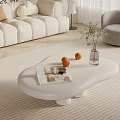 White Curved Coffee Table in Modern Living Room with Magazine Oranges Clear Vase and Plant