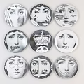 Collection of Circular Badges Featuring Various Face Designs in Black and White Style