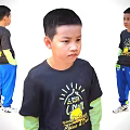 Child Wearing Black T-shirt Yellow Text Green Long Sleeve Undershirt Blue Pants White Sneakers
