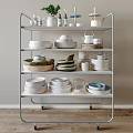 Assorted Kitchenware Displayed on Metal Shelf with Plates Bowls Cups and Jars