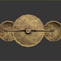 Golden Balance Scales with Green Gemstone on Top and Decorative Metallic Base Against Dark Background