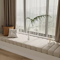 Cozy Bay Window with Beige Cushioned Seat Curtains Pillows and Green Plant