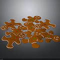 Freshly Baked Gingerbread Men Cookies Orange with White Icing Edges and Green Decorations