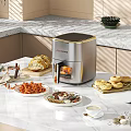 Modern Kitchen Countertop With Air Fryer Cooking Crispy French Fries Bagels And Fresh Bread