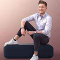 Smiling Man Sitting On Dark Blue Bench In Light Blue Shirt And White Sneakers