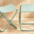 Light Green Modern Single Chair With Metal Frame And Fabric Seat On Wooden Floor