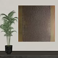 Large Textured Wall Art with Gold Frame and Green Potted Plant on White Wall