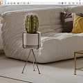 Cactus Bonsai Plant In White Pot With Gold Stand Near White Sofa And Colorful Pillows