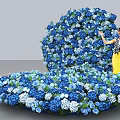 Woman Standing By Latrobe Blue Structure With Blue And White Flowers