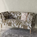 Three-Seater Sofa in Abstract Brown White Pattern with Light Wooden Legs and Decorative Textured Cushion