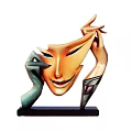 Abstract Sculpture With Orange Mask Face Green Hands And Black Base