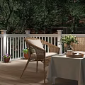 Scenic Evening Patio Landscape With White Railings Wicker Furniture Flower Vase And Trees