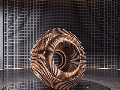 Copper Colored Spiral Sculpture with Metal Strips and Circular Hollow Center in Exhibition Hall 3d model