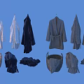White and Black Bathrobes Hanging On Hangers With Folded Towels In Wicker Basket