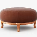 Comfortable Brown Round Leather Stool Featuring Elegant Wooden Legs for Living Space
