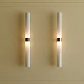 White Cylindrical Wall Lamps With Metal Ring On Beige Wall Decorative Border