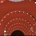 Red Arched Tunnel Interior With White Circular Lights Gray Floor And ICE Sign At End