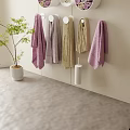 Soft Colored Hanging And Rolled Towels In White Wall Containers With Green Plant