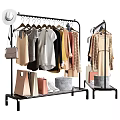 Stylish Clothes On Black Metal Rack With Shopping Bags Handbag And Hat