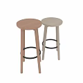 Two Modern Bar Stools With Round Seats And Metal Foot Rests In Different Colors