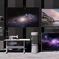 Multiple Modern Televisions Showcasing Galaxy And Landscape Scenes In Room With Table Plant And Fish Tank