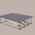 Modern Minimalist Glass Top Coffee Table with Metal Frame and Sand Pile in Indoor Setting