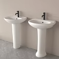 Two White Pedestal Washbasins With Black Faucets Against Light Wall And Gray Floor