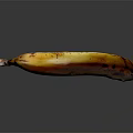 Yellow Banana With Brown Spots On Black Background Showing Reflective Surface