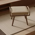 Modern Wooden Stool With Beige Upholstered Seat On Woven Rug In Living Room Space