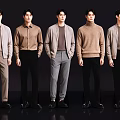 Group of Five Men in Various Stylish Casual Tops and Pants Against Black Background