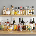 Various Wine Bottles And Glasses Arranged On Display Shelf With Different Labels And Colors