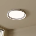 Modern Round White Ceiling Light With Minimalist Design In Room With Window Blinds