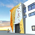 Modern Outdoor Climbing Wall Sports Equipment With Colorful Holds On Building Exterior And Blue Sky