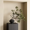 Black Vase With Green Leaf Branches Placed On Dark Cube Base Against Beige Wall 3d model