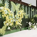 Enchanting Photo Spot With Green Backdrop Yellow White Flowers Green Butterfly Decorations And Floral Arrangements