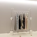 Modern Metal Garment Rack With Spherical Accents And Square Bases Holding Various Colored Clothes