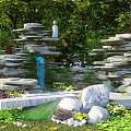 Garden Ornaments Featuring Rockery Stone Formations Lush Green Plants And Decorative Stones