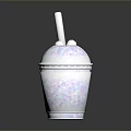 White Smoothie Cup With Colorful Speckles And Straw On Dark Shiny Surface