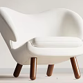 White Upholstered Accent Chair With Modern Curved Design And Brown Wooden Legs