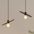 Two Modern Pendant Lights With Leaf Shaped Shades Black Cords and Illuminated Bulbs
