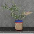 Woven Vase with Blue Red Beige Stripes Holding Green Leaves Pampas Grass on Gray Background
