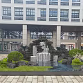 Elegant Garden Landscape with Waterfall Stones Green Plants and Pool in Front of Modern Building