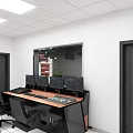 Contemporary Workspace With Long Desk Multiple Monitors Black Chairs White Walls And Glass Partition