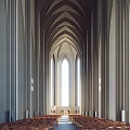 Wooden Chairs In Religious Gathering Place With White Walls Curtains And Natural Light