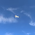 Gray Fighter Jet Flying Over Canyon With Mountainous Landscape And Trees
