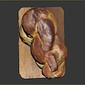 Golden Brown Braided Bread On Wooden Cutting Board With Glossy Finish