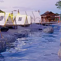 Scenic Camping Site With Luxury Tents Alongside Natural Stream And Green Trees